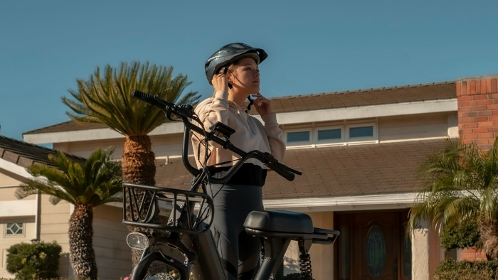 a woman wears helmet to ride bike