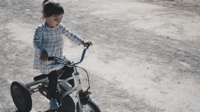 a kid is riding a bike